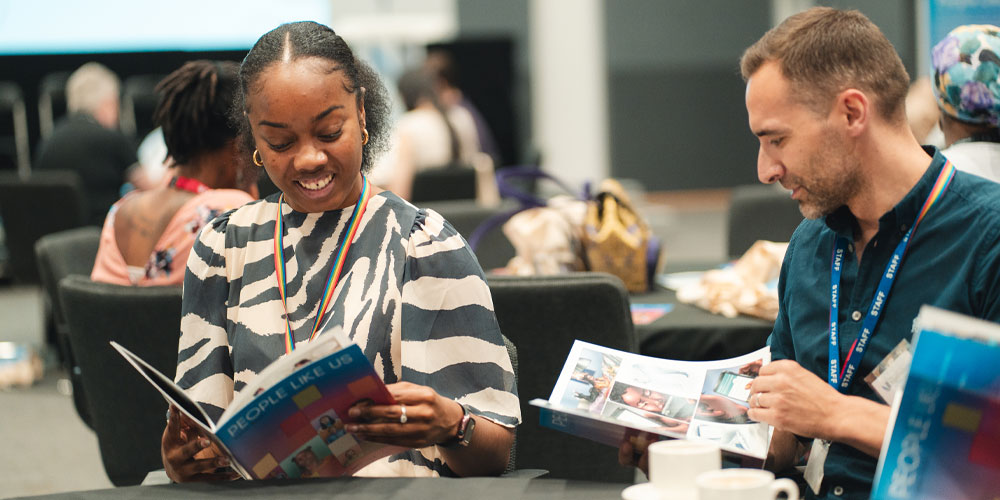 Attendees at the University of West London’s conference, reading the project’s People Like Us comic book