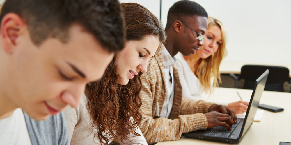 higher education students working at desk