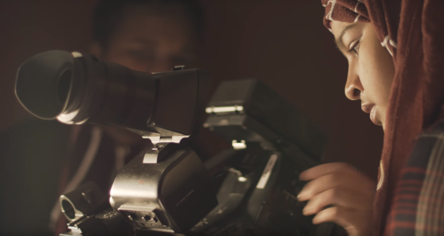 Young student uses a film camera in a studio