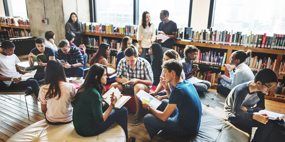 Students discussing work in a university library