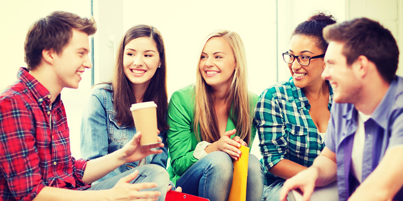 Group of five students talking