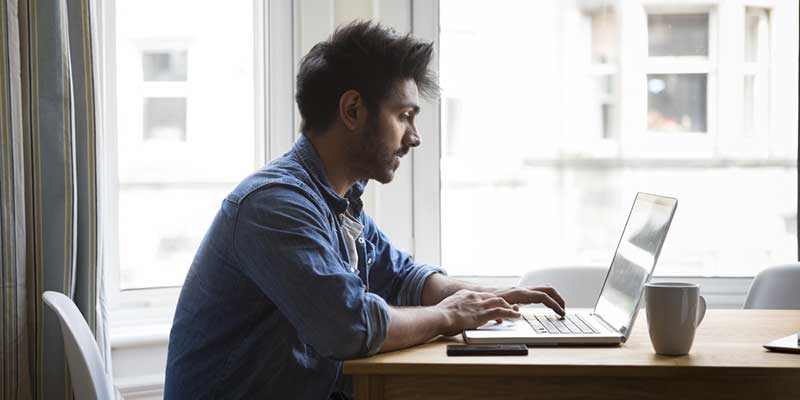 Student at a table with laptop