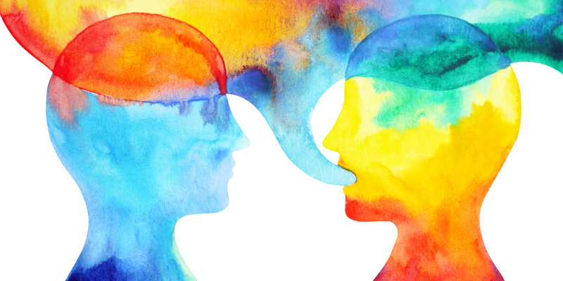 An abstract image of two silhouettes speaking and surrounded by bright colours