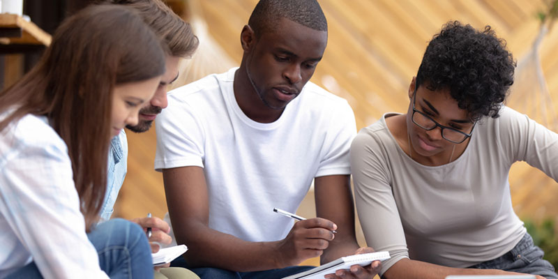 Four students making notes