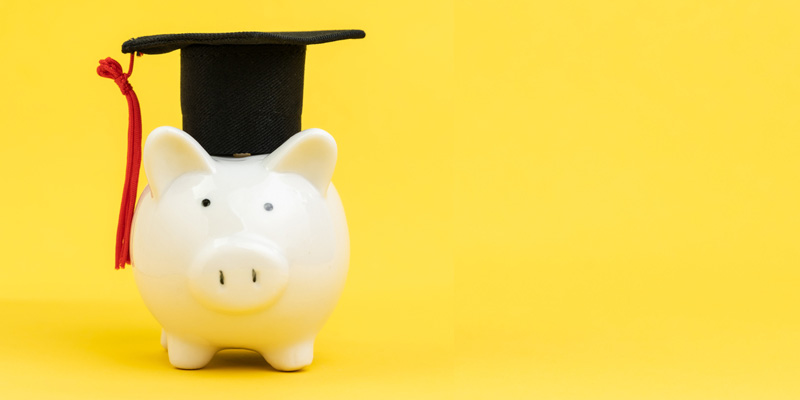 piggy bank wearing mortar board hat, to represent funding for universities