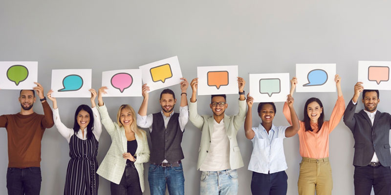 Group of people holding speech bubble signs