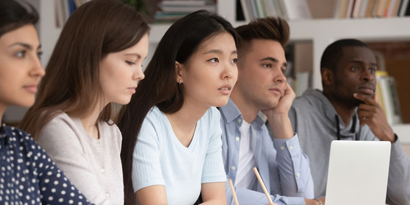 Five university students listening in a lecture