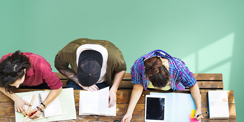 Top view of three students working at a table