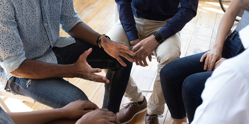 Close up of people's hands talking in a group