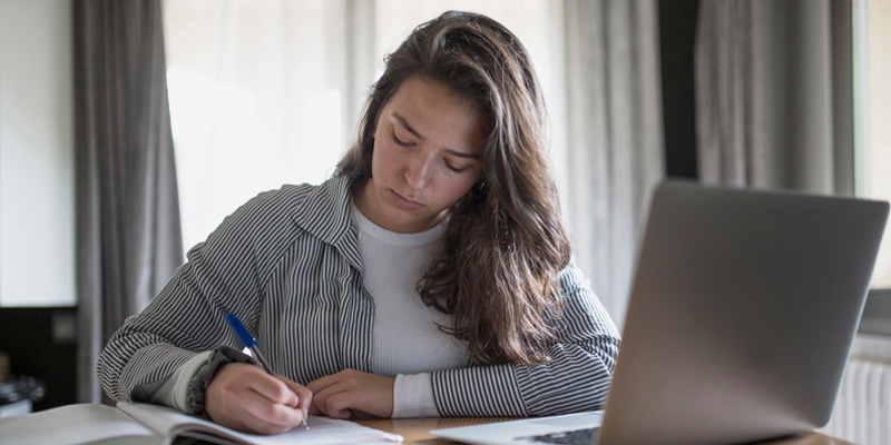 Female student working at laptop