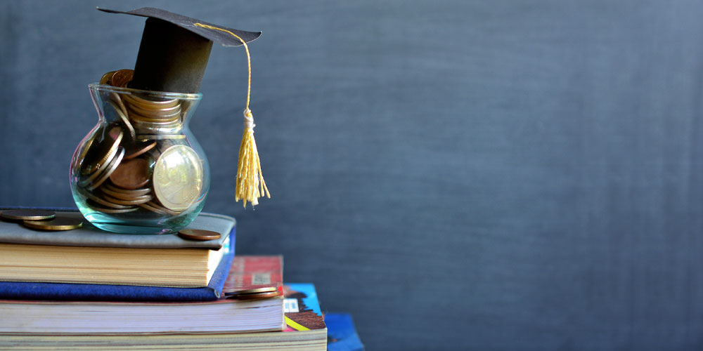 image of graduate mortar-board hat with jar of coins to represent higher education funding