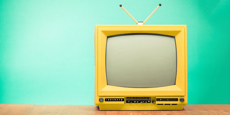 Yellow retro TV on a blue background