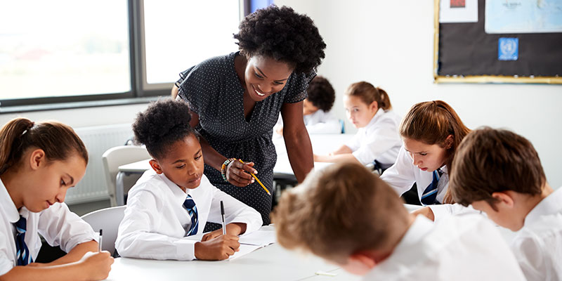 Teacher helping a group of students