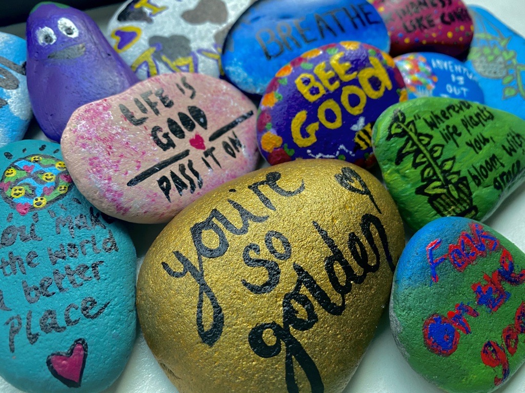 painted rocks with wellbeing messages