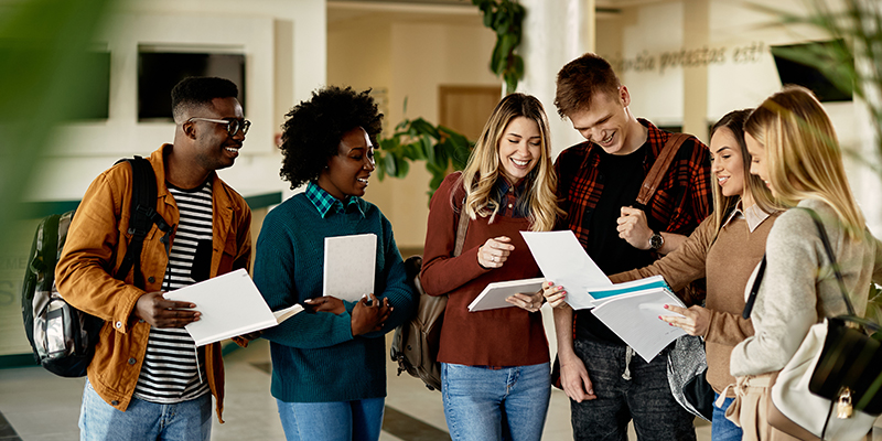 A group of six students comparing notes