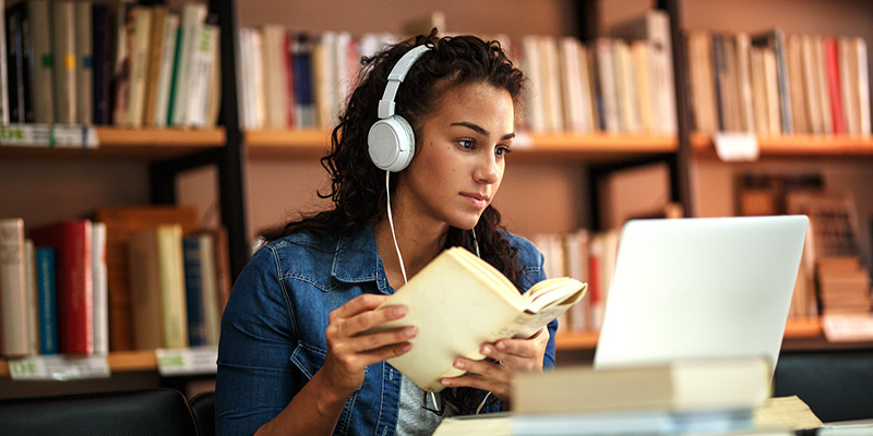 female black student studying in library