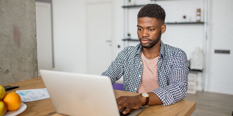 Student sat at a desk with laptop