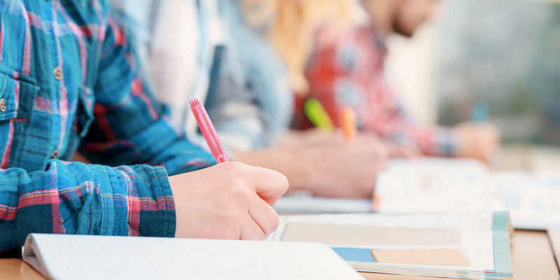 Students writing reports in class