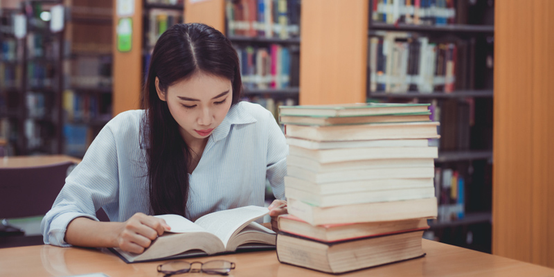 Female Asian student studying in library